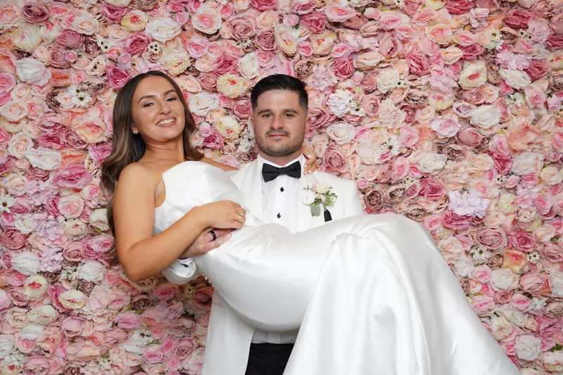 Bride and groom having fun at the photo booth