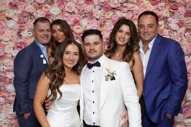 Wedding group posing together at the photo booth