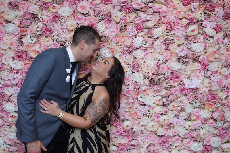Wedding guests laughing at the photo booth