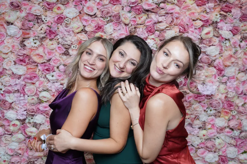Wedding guests posing together at the photo booth