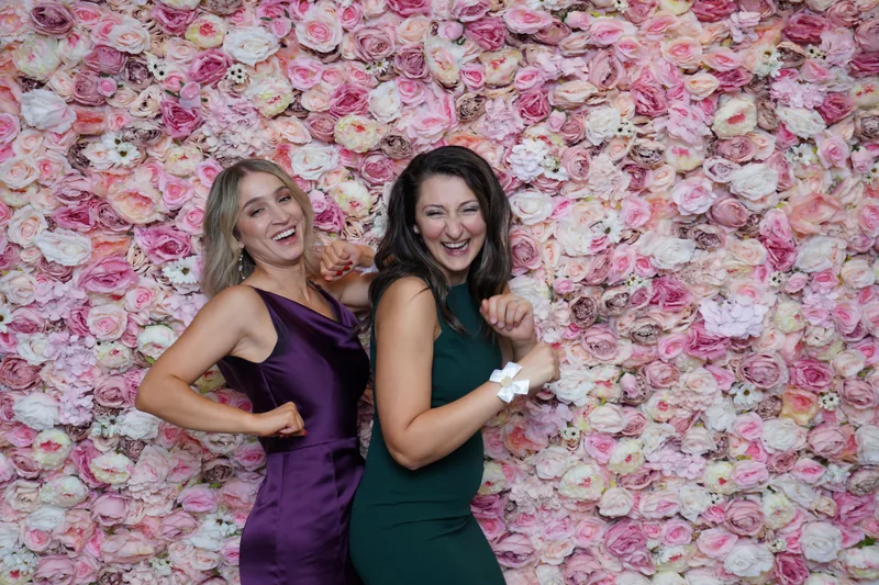Wedding guests laughing at the photo booth